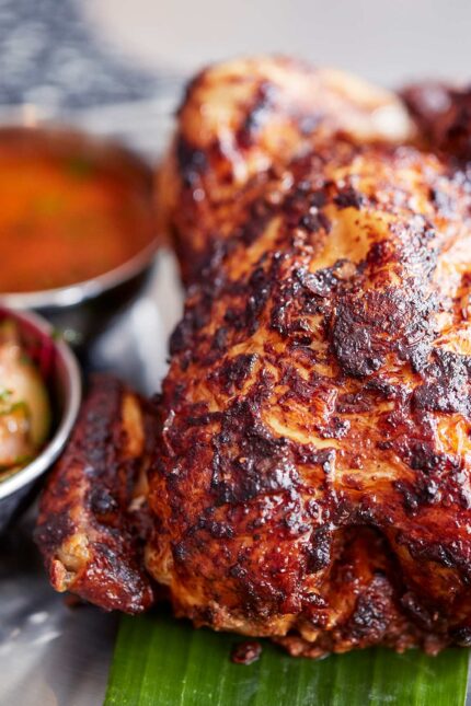 Whole roasted tandoori chicken with salad on the spring menu at Bombay Bustle London.