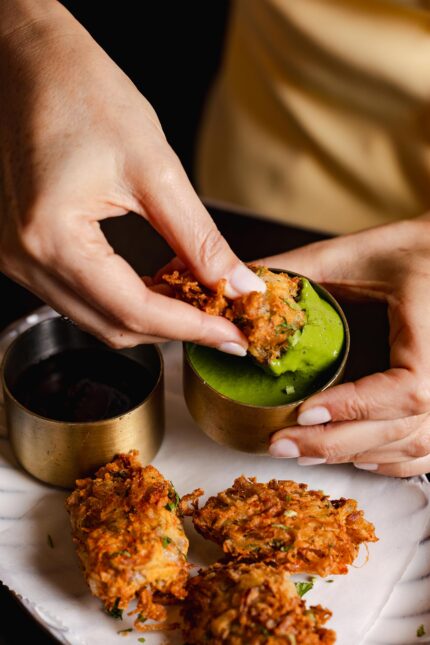 Crispy onion bhajiyas with tangy green chutney on the Monsoon menu in Mayfair London.