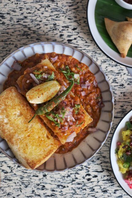Griddled Masala Pao with spicy vegetable stew served on Maddox Street near Oxford Circus.