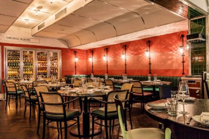 Dining area at Bombay Bustle with luxury booth seating inspired by historic Indian train carriages.