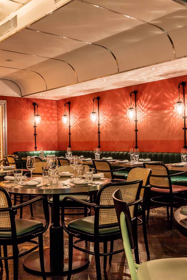 Dining area at Bombay Bustle with luxury booth seating inspired by historic Indian train carriages.