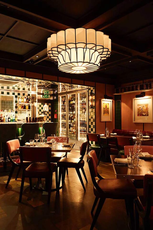 Warmly lit dining room and cocktail bar inside Bombay Bustle Indian restaurant in Mayfair.