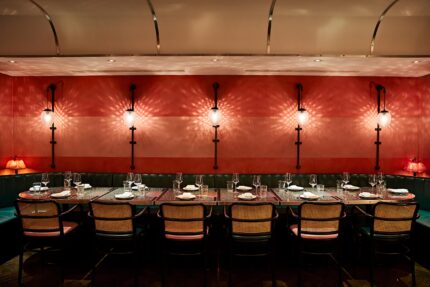 A semi-private sharing table set for an intimate group celebration at Bombay Bustle.