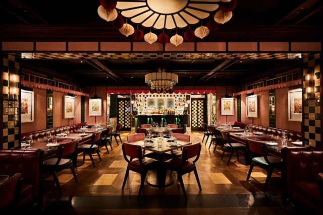 The Retiring Room, featuring deep ruby-toned leather booths and glowing lights for private dining.