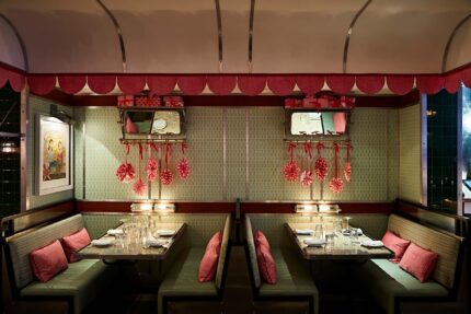 Intimate dining booths lined with mahogany strapwork soft green Formica panels inside The Carriage.