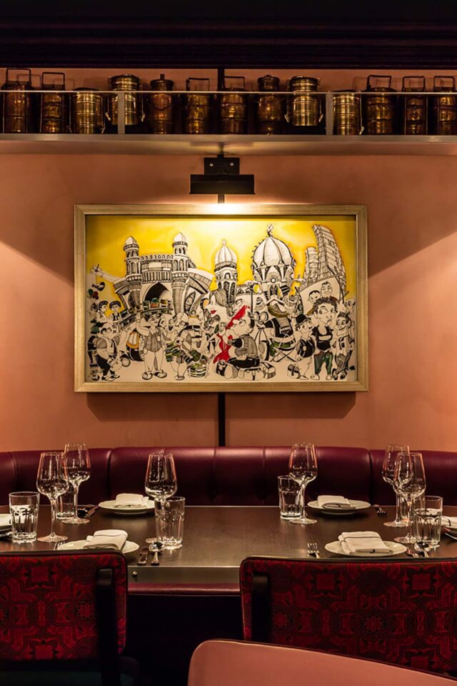 Luxury leather booth seating under art at Bombay Bustle restaurant in Mayfair London.