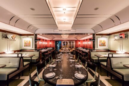 The Carriage dining room at Bombay Bustle in Mayfair, a sharing table set for a group event.